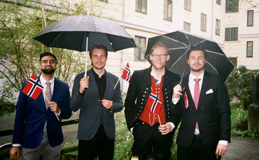 a group of men holding an umbrella