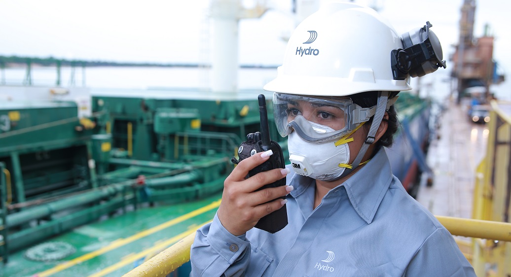 a man wearing a hard hat and holding a camera