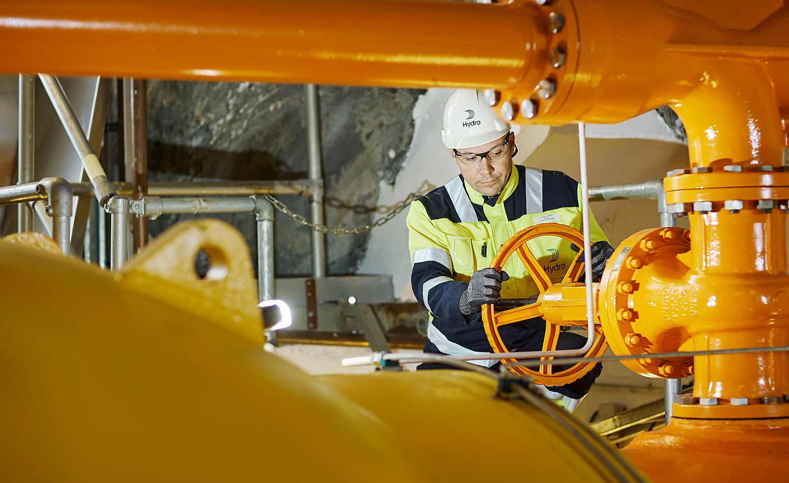 a person in a hard hat working on a machine