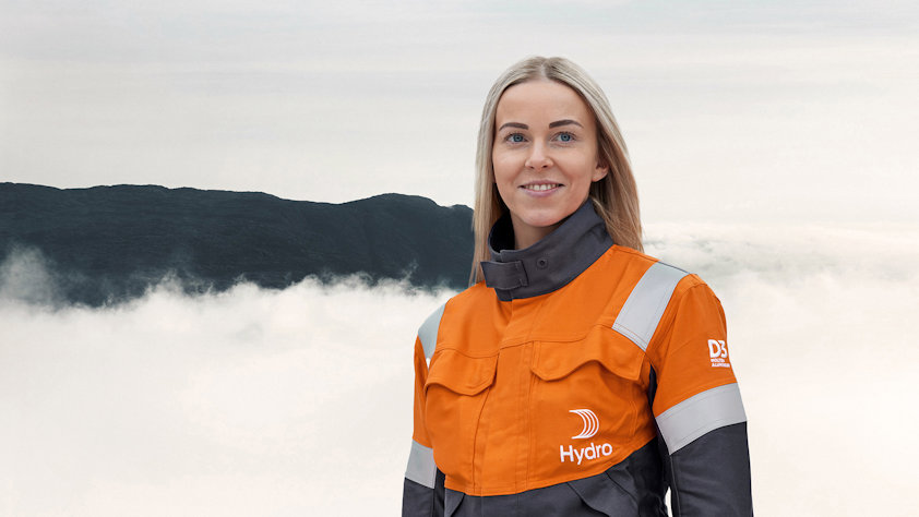 a woman in an orange and grey jacket