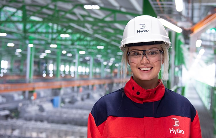 female worker in protective gear on factor floor