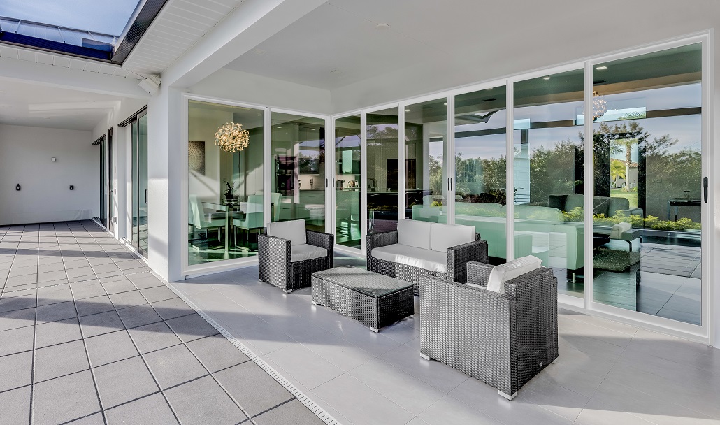 a room with glass walls and a white tiled floor