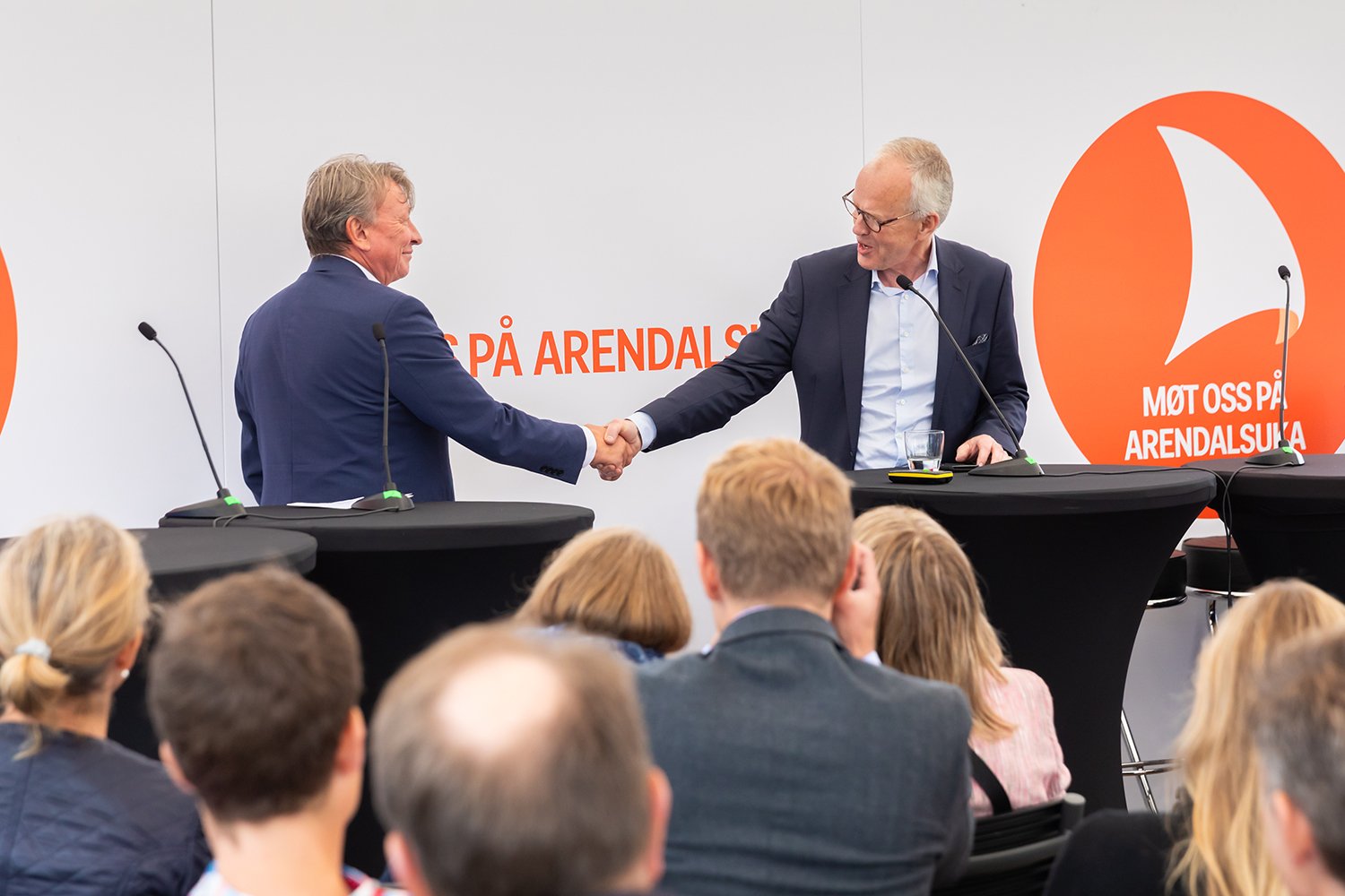 a man shaking hands with a man