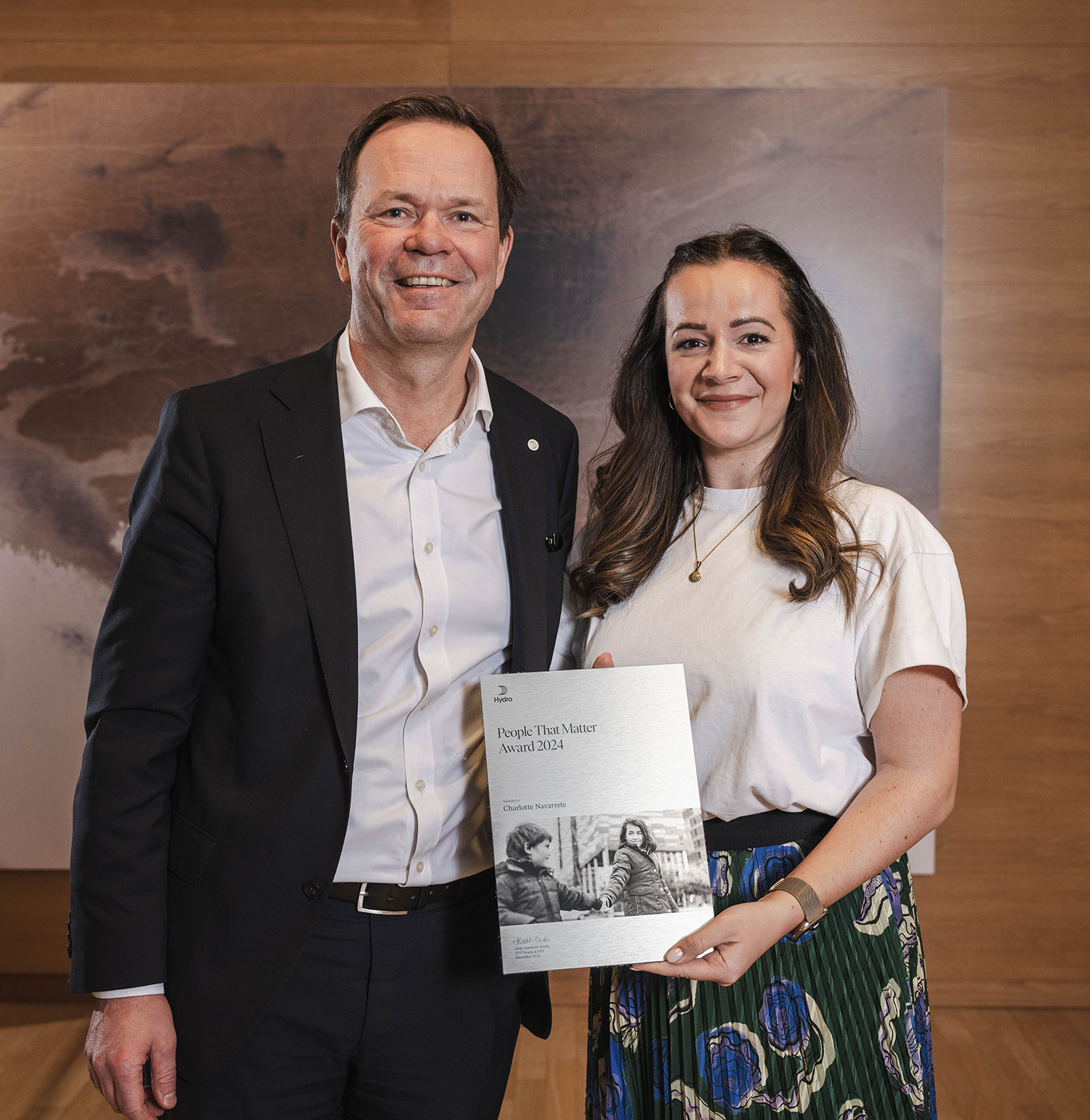 a man and a woman holding a plaque