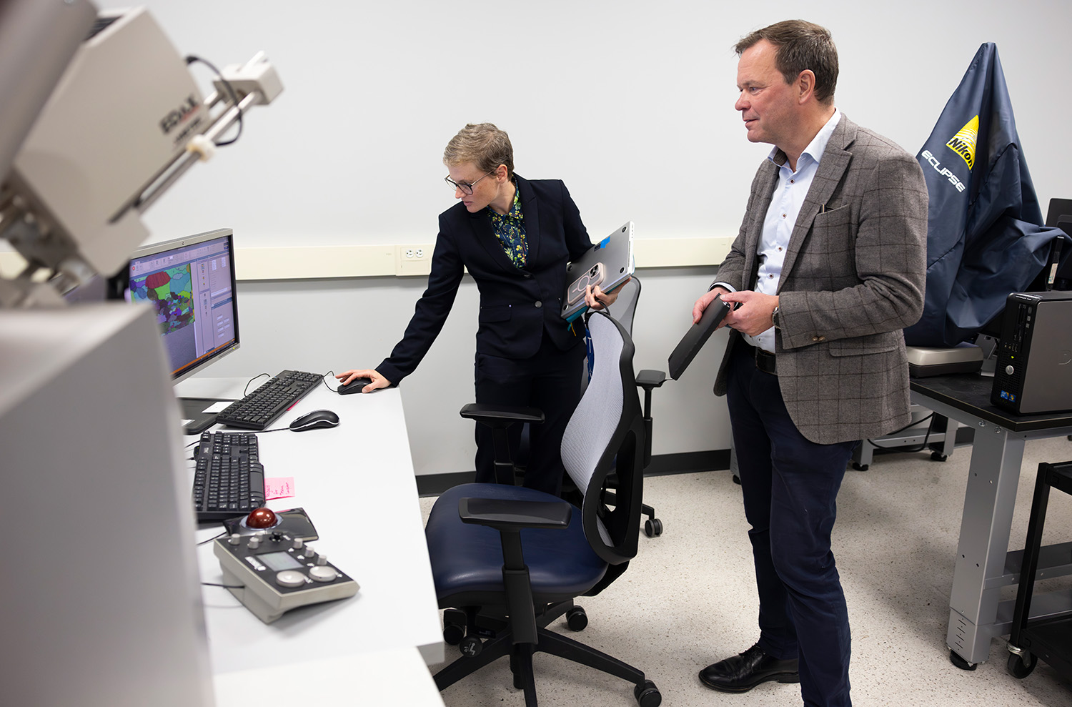 a man and a woman looking at a computer screen