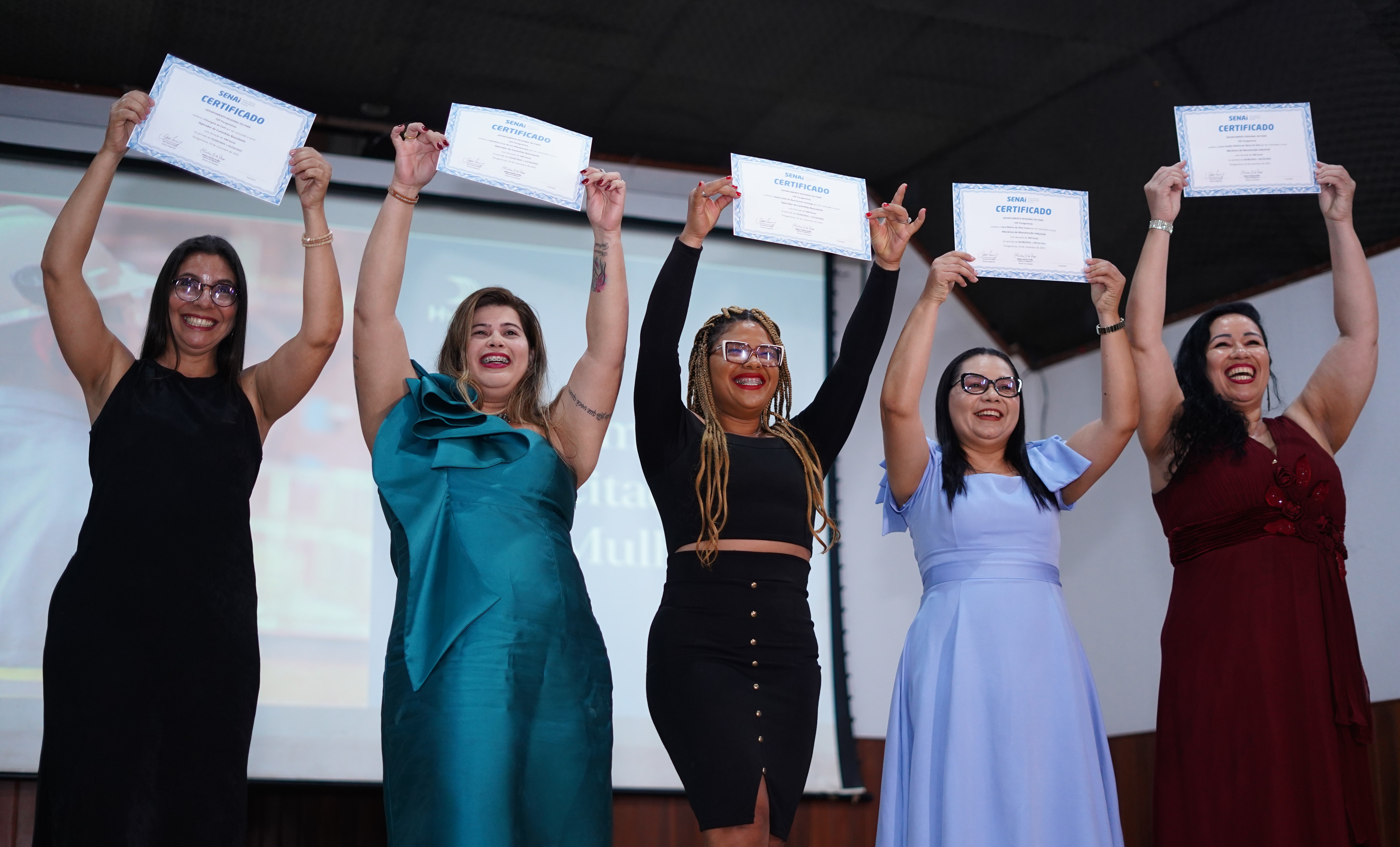a group of women holding up paper