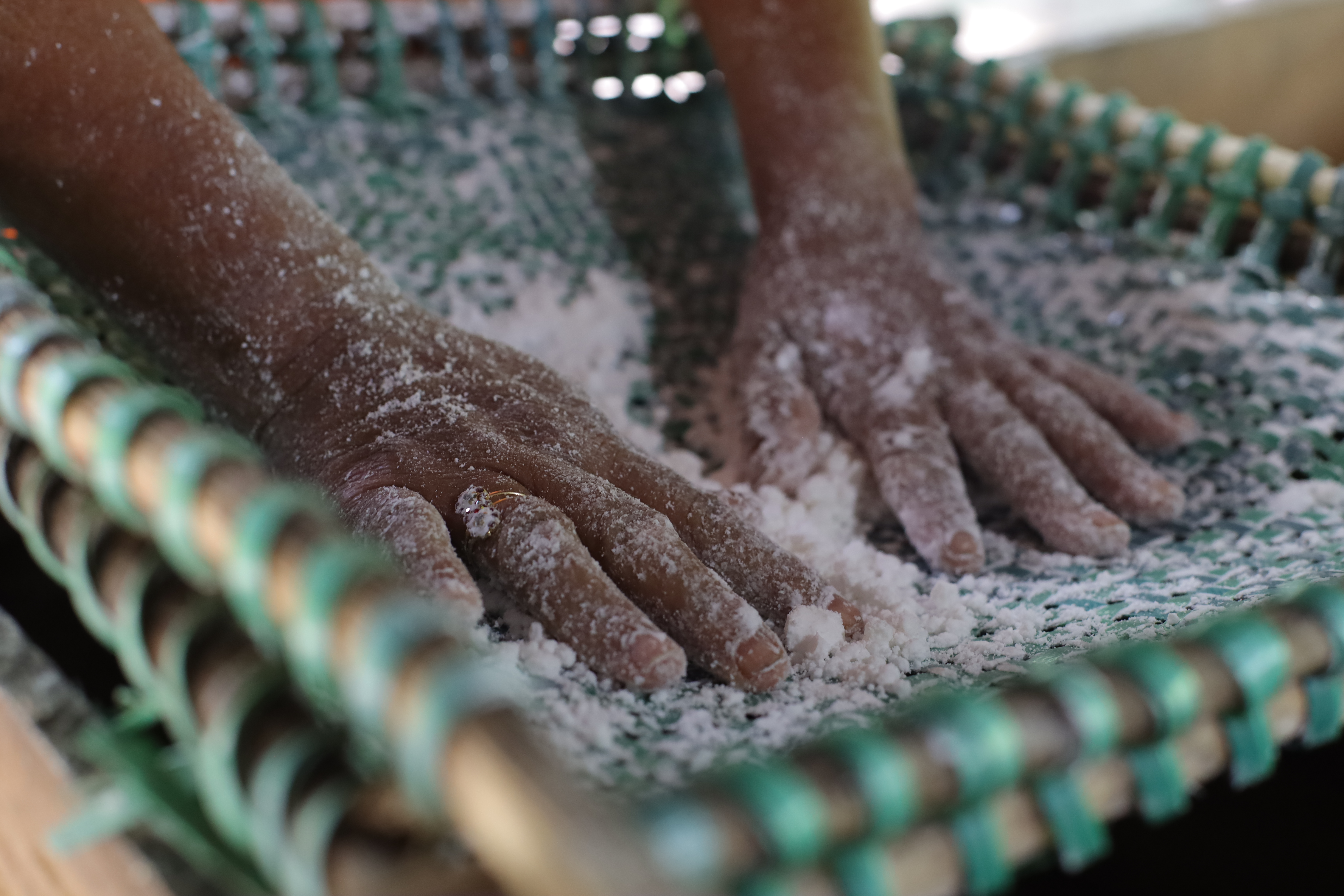 hands on a tray with flour