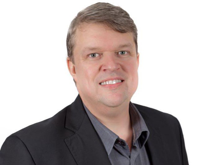 a man wearing a black suit