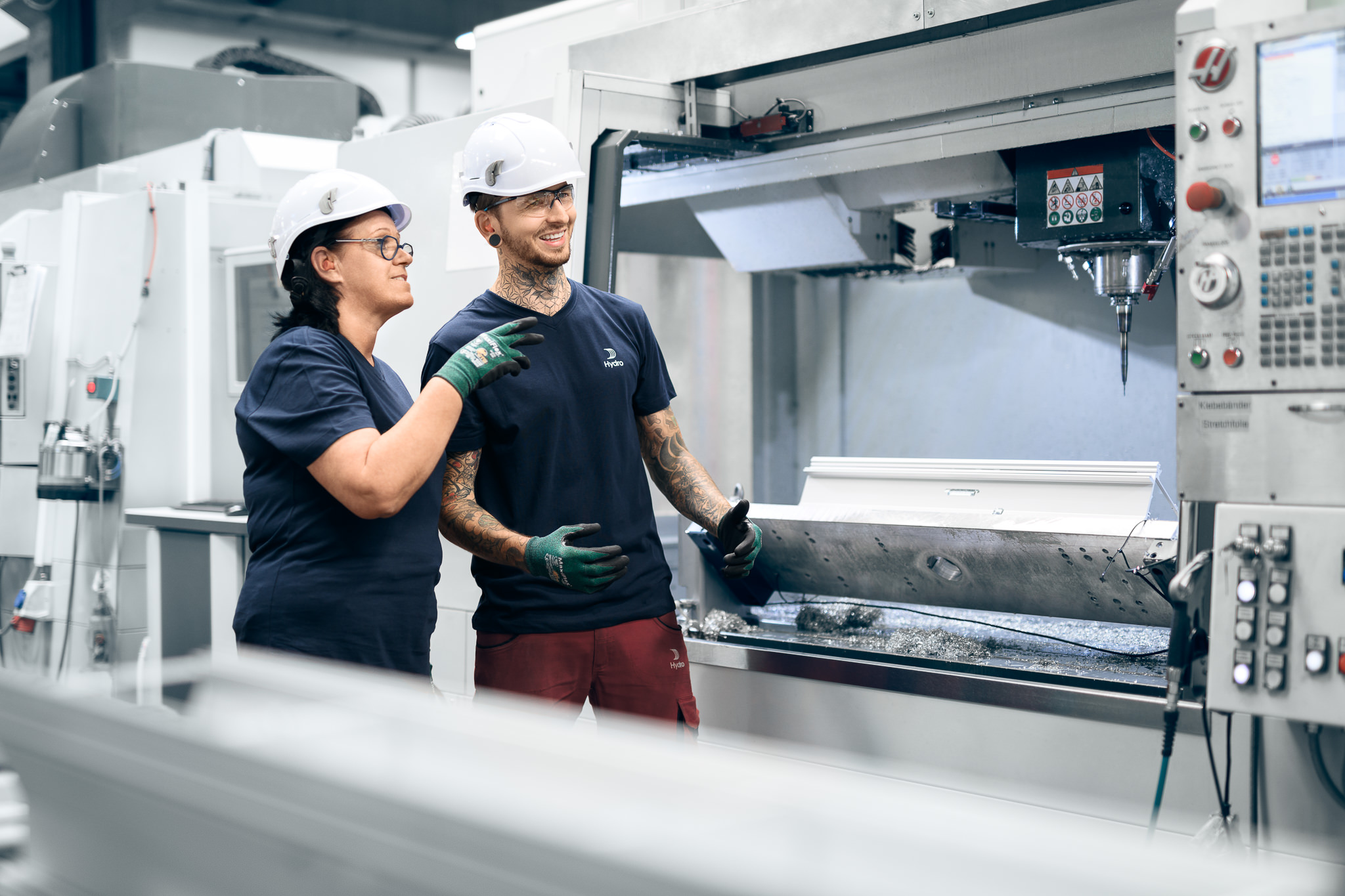 a man and woman wearing hard hats