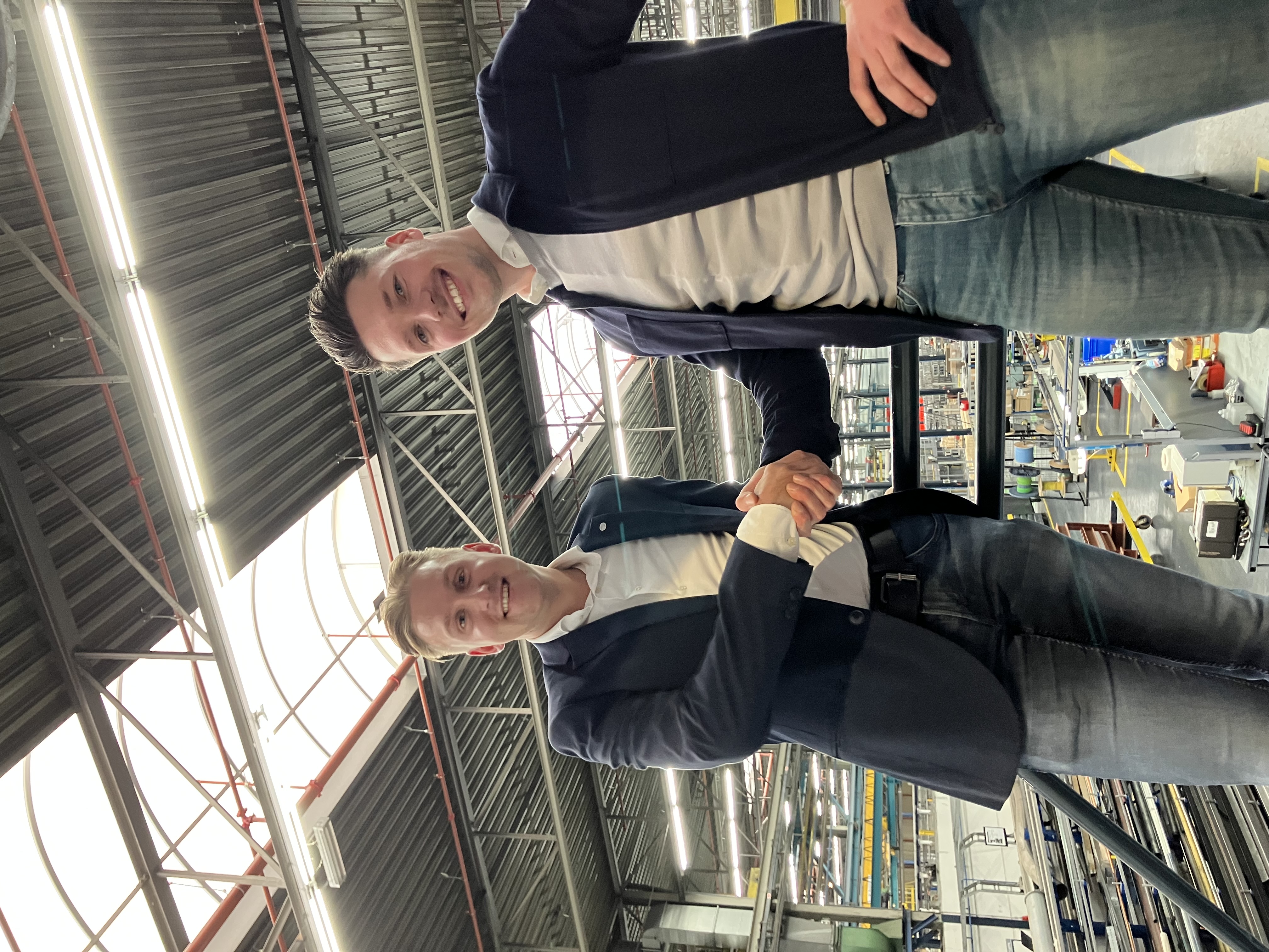 a couple of men smiling